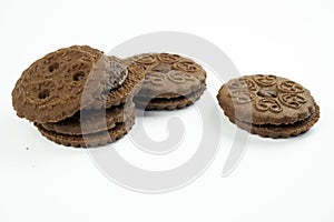 Round chocolate biscuits scattered on a white background