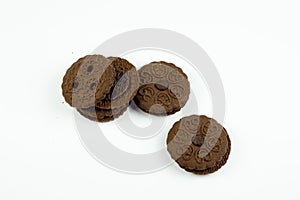 Round chocolate biscuits scattered on a white background