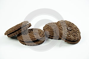 Round chocolate biscuits scattered on a white background