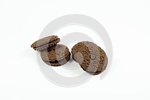 Round chocolate biscuits scattered on a white background