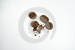 Round chocolate biscuits scattered on a white background