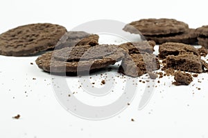 Round chocolate biscuits scattered on a white background