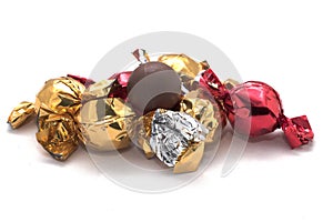 Round chocolate candy with foil packaging isolated on the white background