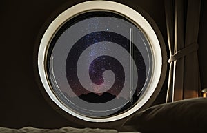 Round circle window frame with night sky full of stars with milky way