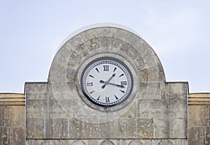 Round clock on the arched pediment of the building.