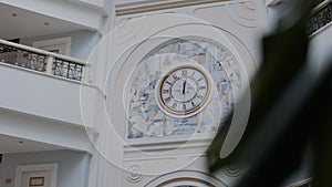 Round clock face with roman numerals on wall indoors