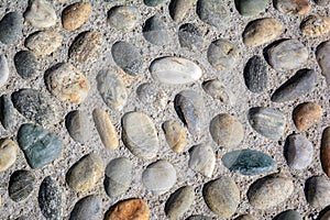 Round cobblestone pebble in concrete, street road pavement
