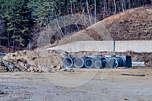 Round concrete culverts on ground at new construction site