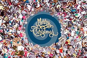 Round confetti frame with Merry Christmas paper wording on classic blue. Perfect background for any holiday project