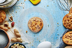 Round cookie with peanuts on the blue wooden background