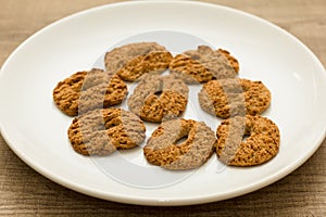 Cookies with a hole, sweet temptation. Dessert on white dish and