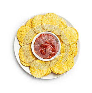 Round corn nacho chips and tomato dip. Yellow tortilla chips and salsa