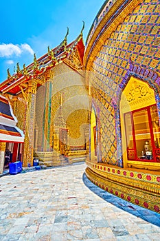 The round courtyard of Wat Ratchabophit temple and golden shrines on sides, Bangkok, Thailand