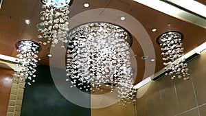 Round Crystal chandelier hanging from ceiling of a hall photo