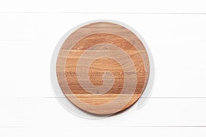 Round cutting board on white table