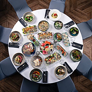 round decorated table with delicious dishes and top view