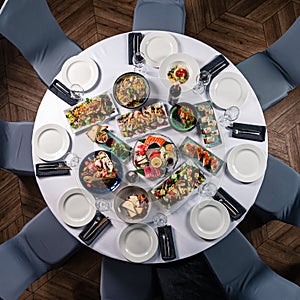 round decorated table with delicious dishes and top view