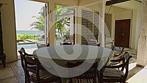 Round dining table in luxury retro villa on tropical island with blue ocean and palm trees views. Place for breakfast