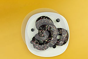Round donuts on a square and white plate