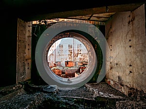 Round door or gate to abandoned nuclear rector or generator room in ruined and destroyed Crimean Nuclear Power Plant