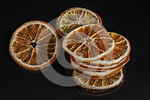 round dried slices of natural orange on a black background