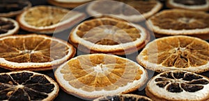 round dried slices of natural orange on a black background as a background