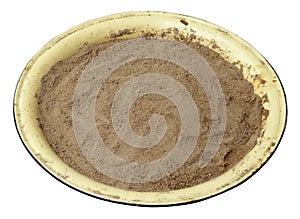 A round enameled metal basin filled with clean building sand.