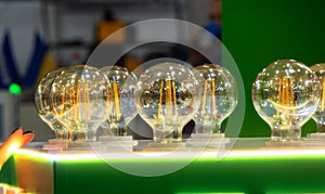 Round energy efficient light bulbs in a glass bulb with warm light