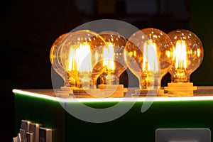Round energy efficient light bulbs in a glass bulb with warm light