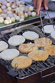 Round flat glutinous rice grilled over charcoal grills