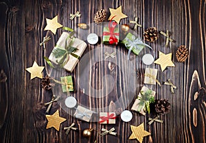 Round frame of Christmas craft gift box on dark background. Winter, new year composition. Flat lay. Top view
