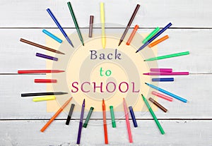 Round frame from colorful felt-tip pens and yellow paper with text & x22;Back to SCHOOL& x22;