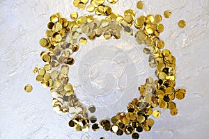 Round frame with golden confetti on coating putty with pearlescent paint with uneven coating with silver gold paint. grunge noise