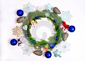 Round frame made of pine branches decorated with Christmas toys isolated on white background. Christmas or New Year concept