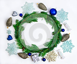 Round frame made of pine branches decorated with Christmas toys isolated on white background. Christmas or New Year concept