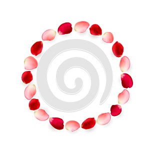 Round frame made of rose petals. Red and pink petals arranged in a circle.