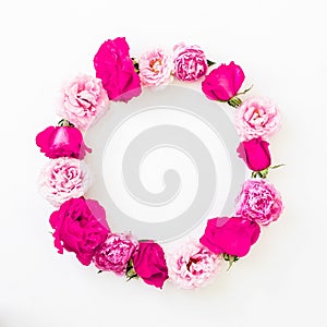 Round frame with pink rose flowers, petals and peonies on white background