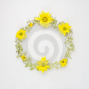Round frame wreath pattern with yellow Chrysanthemums and wild f