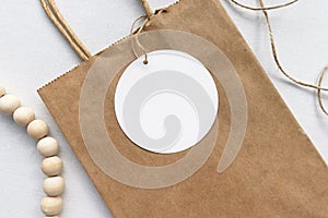 Round gift tag label on a brown paper bag