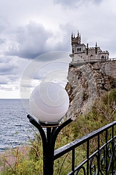 Round glass lantern on the background of the Swallow`s Nest Castle, Crimea, a tourist attraction on the Crimean coast. the touris