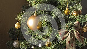 Round golden toy on the Christmas tree weighs