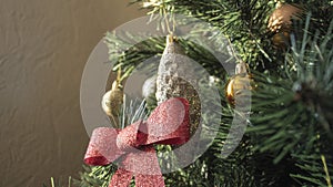 Round golden toy on the Christmas tree weighs