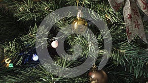 Round golden toy on the Christmas tree weighs