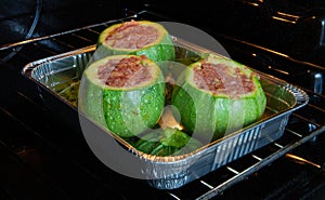 Round green zucchini inside a white plate