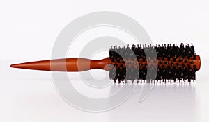 Round hairstyling brush isolated on white.