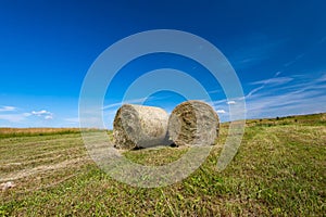 Round hale bays on the top of a hill at summertime