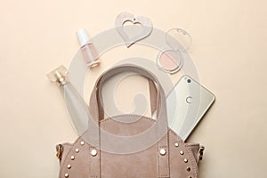 Round handbag, smartphone and various women`s cosmetics