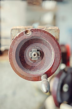 A round handle of an old rusty machine metal mechanism