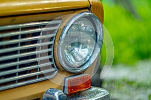 Round headlight of an old car close-up