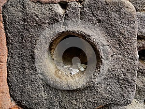 Round hole in a large square stone